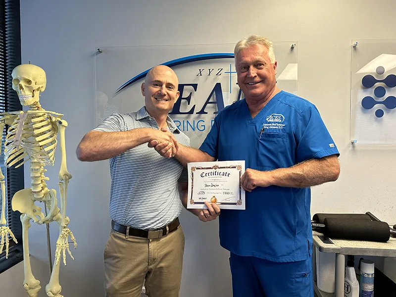 Dr. Brian Douglas receiving his Team Ring Dinger certificate